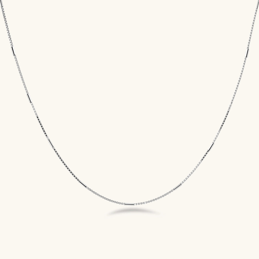 Delicate platinum-plated sterling silver necklace with alternating textured cubic links and smooth chain sections.